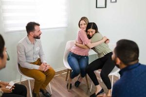 men and women meet in group therapy program