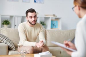 man begins 12 step addiction treatment program with therapist