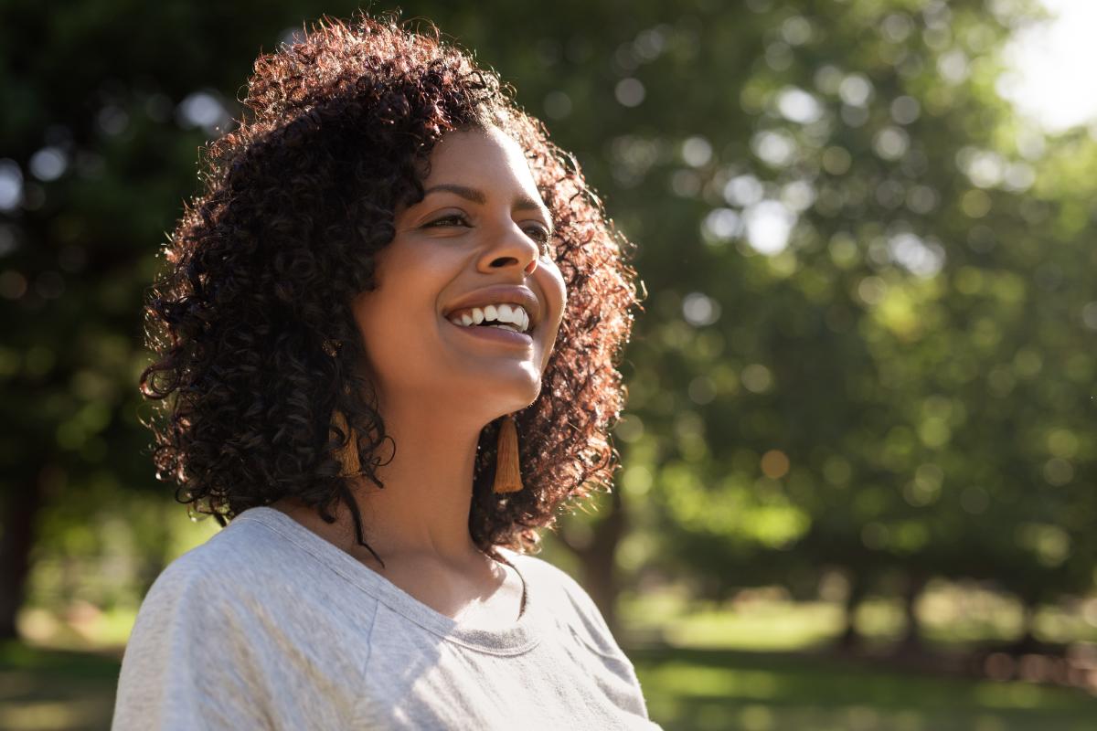 person outside smiling about recovery during holidays