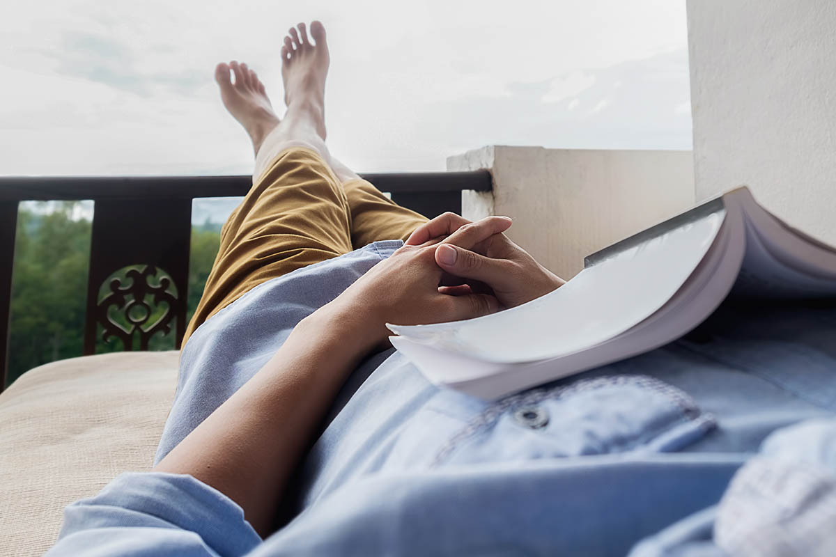 person laying down with book on chest because they were feeling anxious